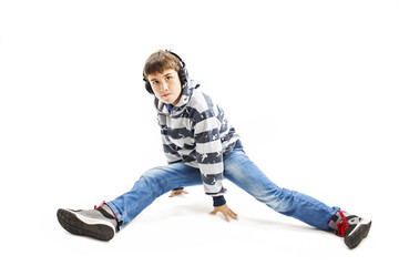 Young man with ear-phones dancing hip-hop. Isolated on white background