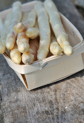 asperges landes dans barquette sur fond bois 