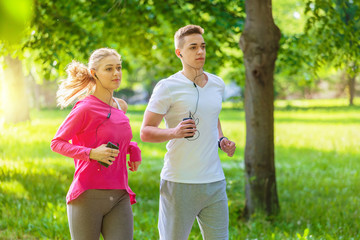 Running couple jogging in the park