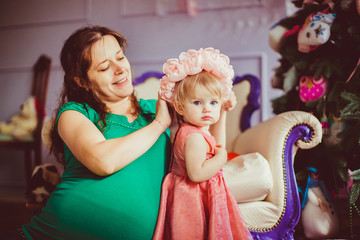 Mother and a daughter in the wreath from flowers