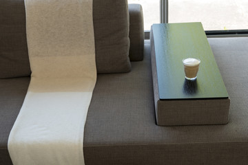 Cappuccino coffee on cozy sofa