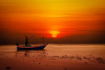 Small boat at the Andaman Sea at sunset