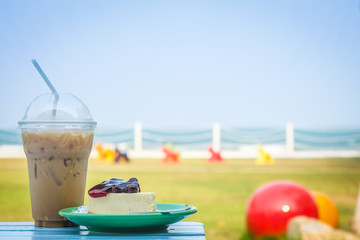 Ice coffee and blueberry cheese cake on the beach