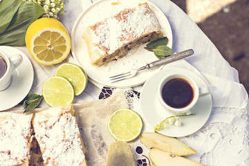 .pie, strudel with pear and lemon. Cup of coffee. .Picnic, Breakfast in nature. Food in nature.