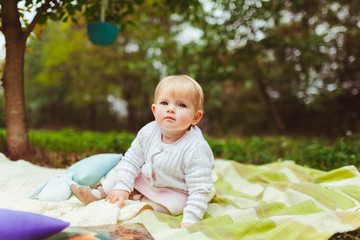 Glance of the happy little baby on the blanket