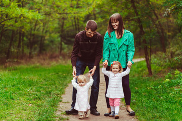 Fototapeta premium Emotional family in the forest with the little kids