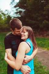 Lovely embracement  of the young parents in the park