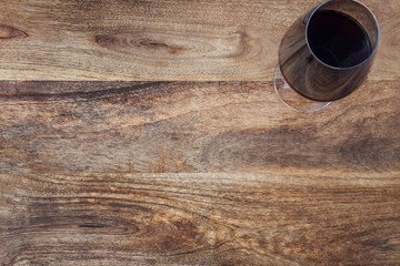 Rustic wooden table with glass of wine