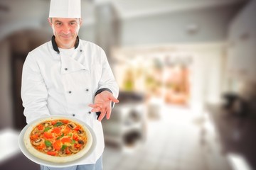 Fototapeta na wymiar Composite image of chef displaying delicious pizza