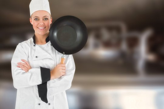 Composite image of female chef with arms crossed holds frying pa