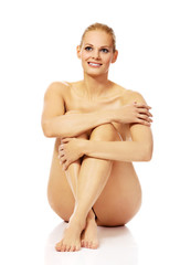 Obraz premium Smile nude woman sitting on the floor