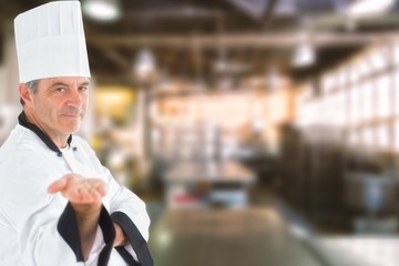 Composite image of male chef presenting an invisible product 