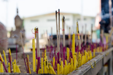blurry focus incense and candles for worship Buddha