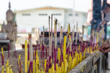 blurry focus incense and candles for worship Buddha