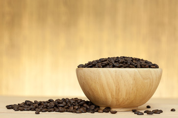 coffee bean in bowl on wooden table