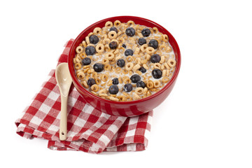 blueberries with cereal and milk in red bowl