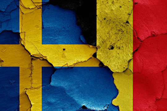 flags of Sweden and Belgium painted on cracked wall