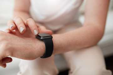 Obraz na płótnie Canvas Woman checking time on her smart watch