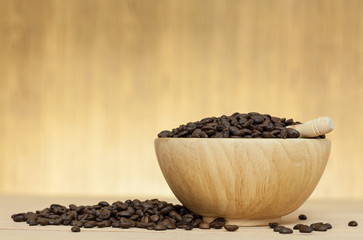 coffee bean in bowl on wooden table