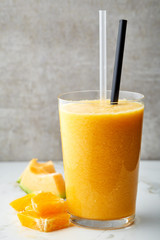 glass of orange and melon smoothie