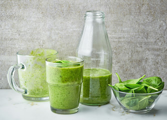 glass and bottle of green smoothie
