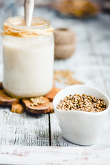 Obraz na płótnie Canvas vegan fresh milk from hemp seeds in a glass jar