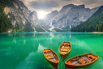 Stunning mountain lake with wooden boats in the Dolomites,Italy