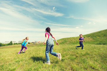 group of happy kids running outdoors