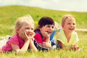 group of kids lying on blanket or cover outdoors