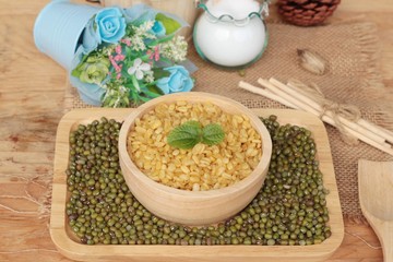 Soy beans and dry beans on wood background.