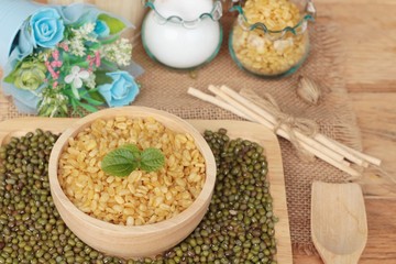 Soy beans and dry beans on wood background.