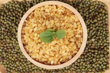 Soy beans and dry beans on wood background.