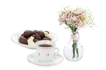 easter eggs plate with flower vase and mug of tea