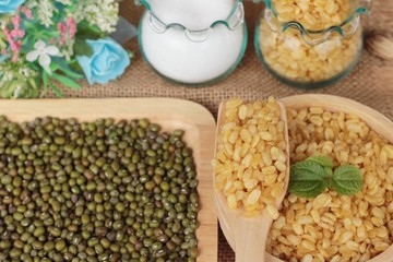 Soy beans and dry beans on wood background.