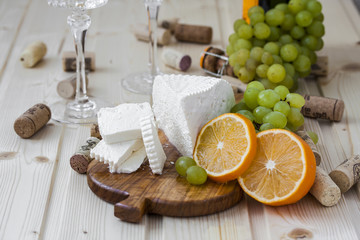 cheese with grapes and a glass of champagne