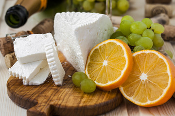 cheese with grapes and a glass of champagne