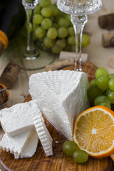 cheese with grapes and a glass of champagne