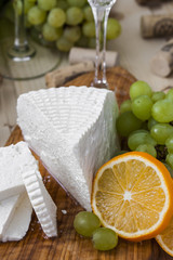 cheese with grapes and a glass of champagne