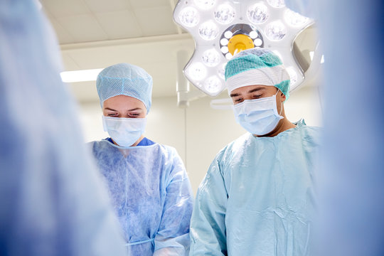 group of surgeons in operating room at hospital