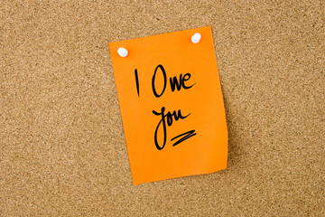 I Owe You written on orange paper note