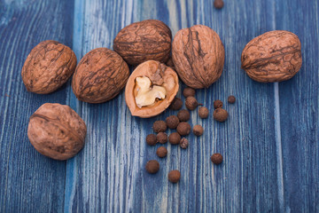 Walnuts and spices on blue wood