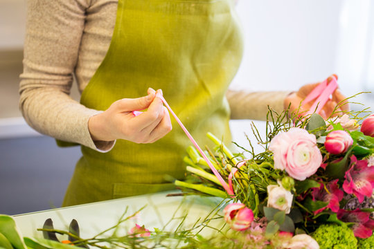 close up of woman making bunch at flower shop