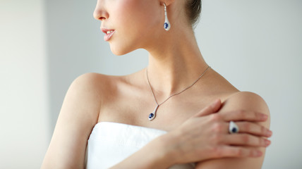 beautiful woman with earring, ring and pendant