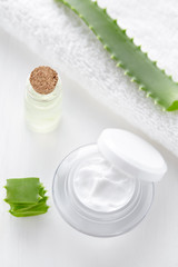 Fototapeta na wymiar Aloe vera cosmetic anti wrinkle cream with herb slice skincare hygiene moisture lotion wellness therapy mask in product container jar with towel on white background