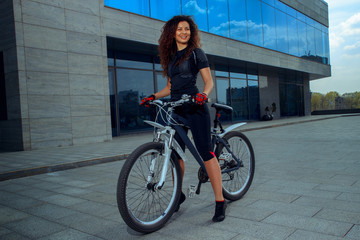Plakat cutie young brunette on bicycle smiling
