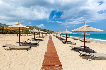 Beach umbrellas and loungers at greek sea