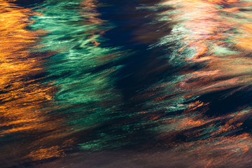 City lights reflection. Colorful glare on the water