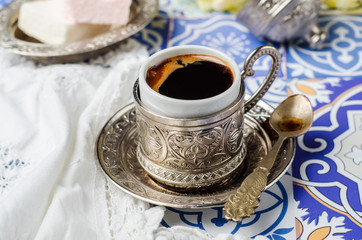 turkish coffee cup  with locum on ornament background. selective focus