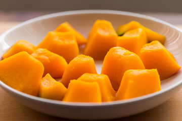 Slices of boiled pumpkin on white dish