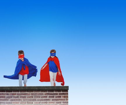 Composite image of masked kids running pretending to be superher